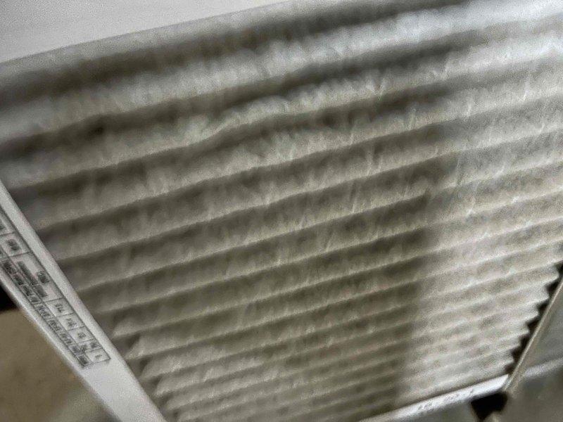 Completed comprehensive BFMA tune-up on 4+ year old air conditioning system as first stop of the day per client's schedule requirements. Performed full system inspection, documenting existing air filter condition showing moderate dust accumulation and debris buildup on pleated media. Inspected outdoor condenser unit, noting significant dirt and debris accumulation on heat exchanger coil fins and aluminum fin surfaces, with uniform environmental contamination present across coil face. Verified condensate pan condition and confirmed structural integrity of coil fins despite heavy surface soiling. System operational upon completion of tune-up service.