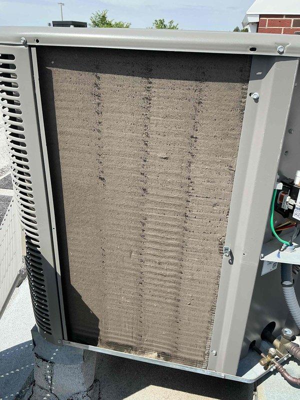 # HVAC Service Completed

Performed comprehensive air conditioning tune-up on residential system consisting of outdoor condensing unit and indoor air handler, both over one year old. Conducted thorough inspection of all system components to ensure optimal performance and efficiency.

Upon arrival, coordinated entry with homeowner who required 30-minute advance notice. No special scheduling considerations were noted for the service appointment.

**Indoor Air Handler Inspection:**
Accessed air handler located in kitchen area and removed existing air filter for inspection. Found 12x20x1 pleated filter heavily loaded with dust and debris accumulation throughout the media, significantly restricting airflow. Documented filter condition with photography. Filter replacement was necessary to restore proper system airflow and prevent strain on blower motor and reduced cooling efficiency.

**Outdoor Condensing Unit Service:**
Inspected outdoor condensing unit and removed access panel to evaluate 