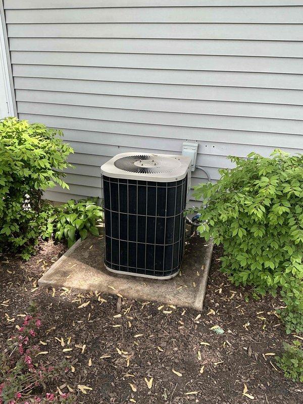 Conducted on-site evaluation of existing HVAC system to provide replacement estimate for aging air conditioning condenser unit and evaporator coil. Current system operational but nearing end of service life, prompting proactive replacement consideration. Documented existing indoor furnace and air handler configuration with PVC venting system, metallic plenum connections, and ductwork arrangement in basement installation. Assessed outdoor condenser unit positioned on concrete pad against exterior wall with proper clearances and electrical disconnect. Photographed equipment specifications and installation conditions to prepare comprehensive replacement proposal. Customer eligible for membership discount credits applicable toward new air conditioning and furnace equipment.