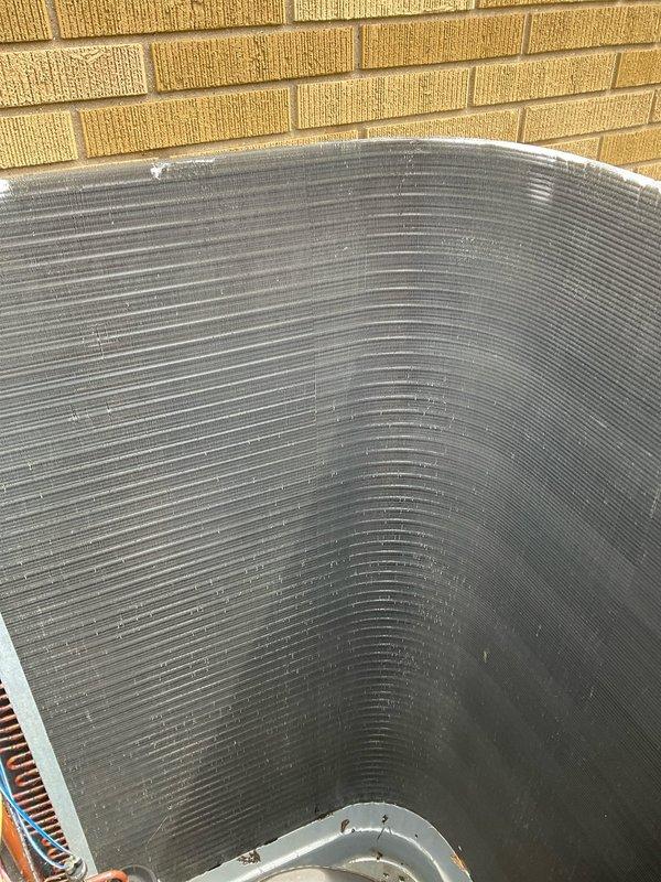 Completed comprehensive BFMA tune-up service on residential air conditioning system over 4 years old. Performed standard maintenance protocol including inspection of outdoor condenser unit with circular finned coil assembly, verified proper operation of all components, and assessed indoor equipment located in basement utility area. System evaluated and found operating within normal parameters following tune-up procedures.
