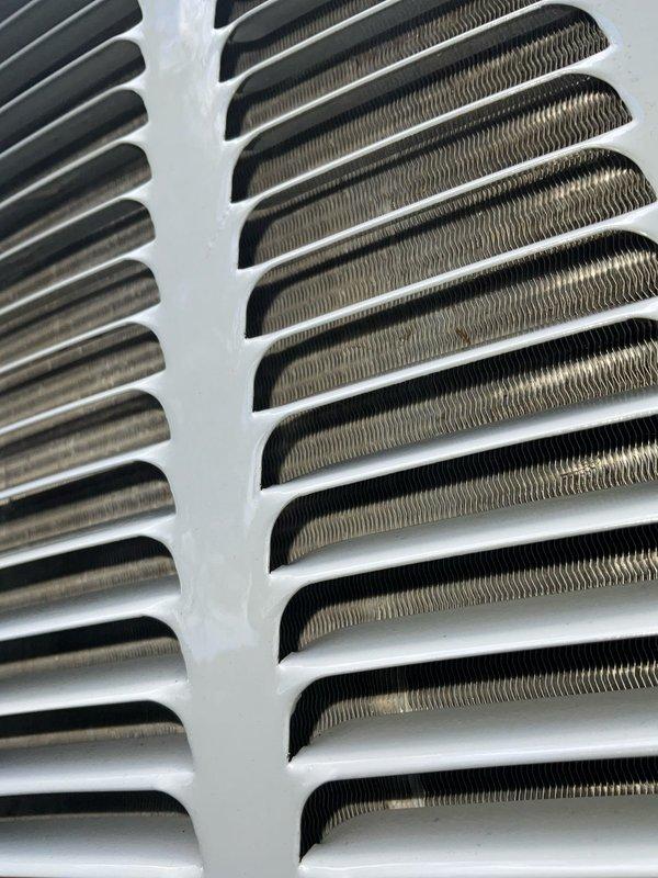 Completed comprehensive AC tune-up service on Goodman outdoor condensing unit as part of recurring maintenance agreement. Performed standard inspection of condenser coils, verified proper fin condition and airflow, documented unit specifications and safety labels, and confirmed system is operating within manufacturer parameters. All components found in satisfactory condition with no immediate repairs required.