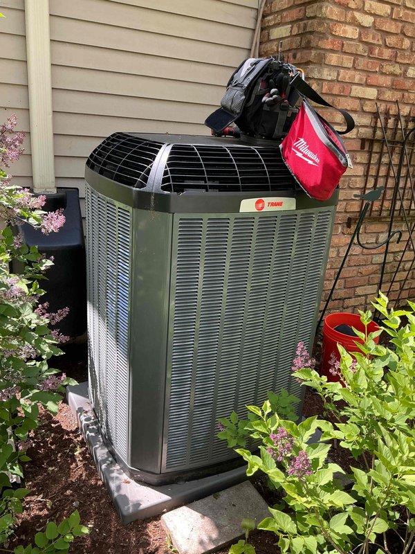 Completed comprehensive BFMA tune-up service on residential Trane air conditioning system. Performed full system inspection including condenser coil cleaning, refrigerant level verification, electrical connection testing, and fan motor operation assessment. Unit showed normal wear for age with minor surface oxidation on cabinet; all components operating within manufacturer specifications and system ready for cooling season.