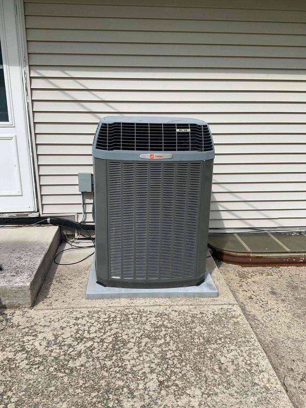 Completed comprehensive BFMA preventive maintenance tune-up on residential Trane air conditioning system. Performed full system inspection including condenser unit evaluation, verified proper electrical connections at disconnect box, checked refrigerant levels, cleaned condenser coils, inspected cabinet and louvers for damage, confirmed proper drainage, and tested system operation. Unit found in good working condition with no immediate repairs required; all components functioning within normal parameters.