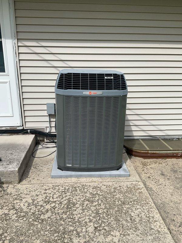 Completed comprehensive BFMA preventive maintenance tune-up on residential Trane air conditioning system. Performed full system inspection including condenser unit evaluation, verified proper electrical connections at disconnect box, checked refrigerant levels, cleaned condenser coils, inspected cabinet and louvers for damage, confirmed proper drainage, and tested system operation. Unit found in good working condition with no immediate repairs required; all components functioning within normal parameters.