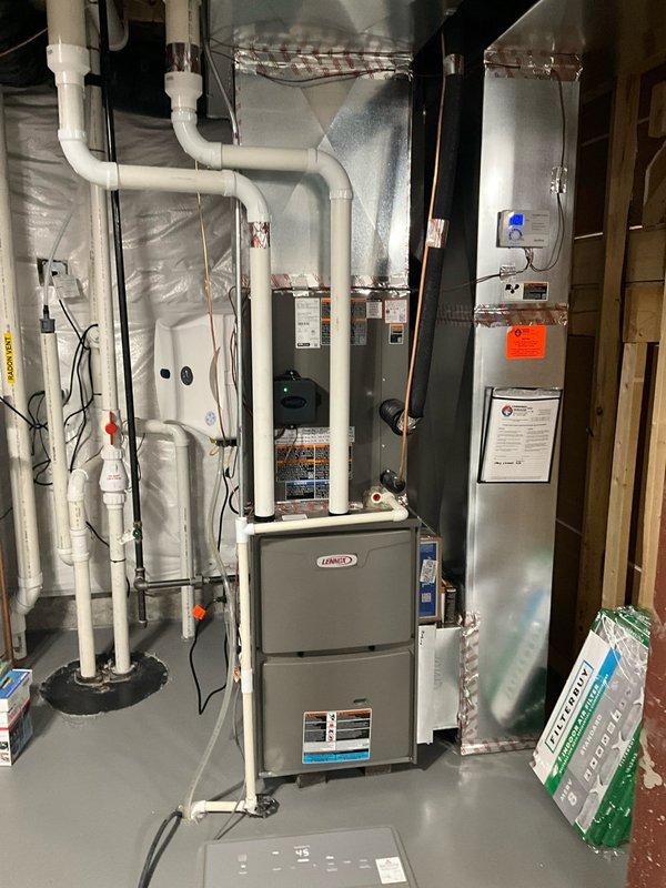 Completed comprehensive BFMA preventive maintenance tune-up on residential Lennox HVAC system. Inspected furnace unit, air handler, ductwork connections, and verified thermostat operation displaying proper temperature readings at 68°F with system functioning within normal parameters. All equipment components, electrical connections, PVC condensate lines, and safety controls examined and found in satisfactory working condition with no immediate service needs identified.