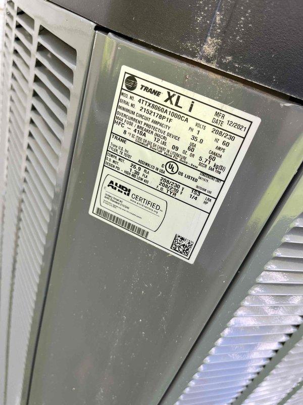 Completed comprehensive BFMA tune-up service on Trane 4TTX4060A1000CA outdoor condensing unit. Inspected condenser coil and fins, noting moderate accumulation of dirt, dust, and environmental debris between fin spacing that required attention. Performed standard preventive maintenance procedures including system evaluation, component inspection, and documentation of unit condition with electrical specifications verified at 208-230V operation.