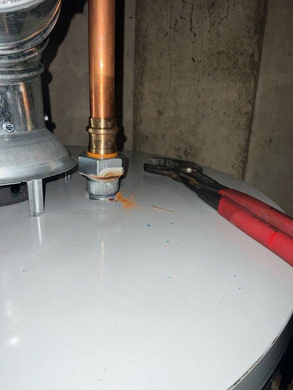 Completed plumbing maintenance visit to inspect water heater for corrosion concerns. Upon arrival, performed thorough visual examination of water heater tank, copper supply piping, brass fittings, and connection points at top of unit. Inspected all accessible plumbing connections, including hot and cold water lines, pressure relief valve assembly, and pipe joints for signs of corrosion, leaks, or deterioration. Documented existing conditions with photographs showing copper piping with brass fittings, flue vent assembly, and overall water heater installation in basement utility area. All connections appear secure with proper clearances maintained around equipment.