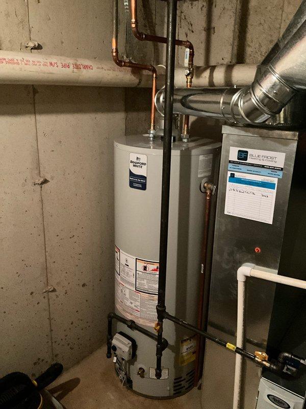 Completed plumbing maintenance visit to inspect water heater for corrosion concerns. Upon arrival, performed thorough visual examination of water heater tank, copper supply piping, brass fittings, and connection points at top of unit. Inspected all accessible plumbing connections, including hot and cold water lines, pressure relief valve assembly, and pipe joints for signs of corrosion, leaks, or deterioration. Documented existing conditions with photographs showing copper piping with brass fittings, flue vent assembly, and overall water heater installation in basement utility area. All connections appear secure with proper clearances maintained around equipment.