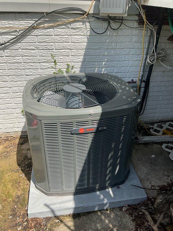 Completed comprehensive BFMA air conditioning tune-up on 2-year-old Trane condenser unit. Removed exterior panels to access condenser coil, which exhibited heavy accumulation of dirt, dust, and debris throughout the fin structure. Performed thorough coil cleaning to restore proper airflow and heat transfer efficiency, reassembled unit, and verified operational performance.