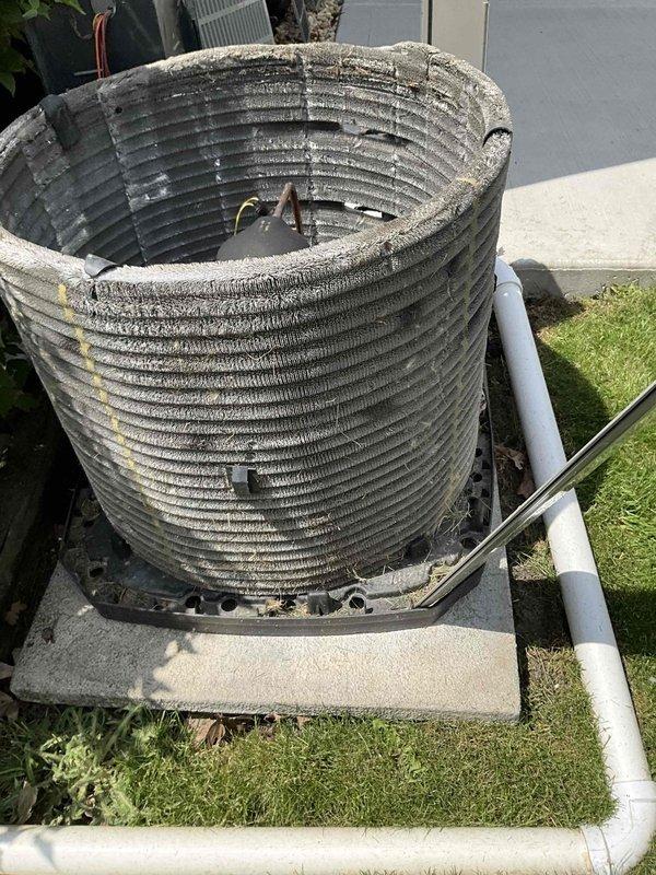 Completed comprehensive BFMA tune-up on 10+ year old air conditioning system. Thoroughly cleaned heavily soiled outdoor condenser coil which had significant dirt and debris accumulation throughout the cylindrical fin surfaces, restored proper airflow and heat transfer efficiency. Inspected indoor air filter showing clean condition with intact pleated media and frame, verified all system components operating within manufacturer specifications.