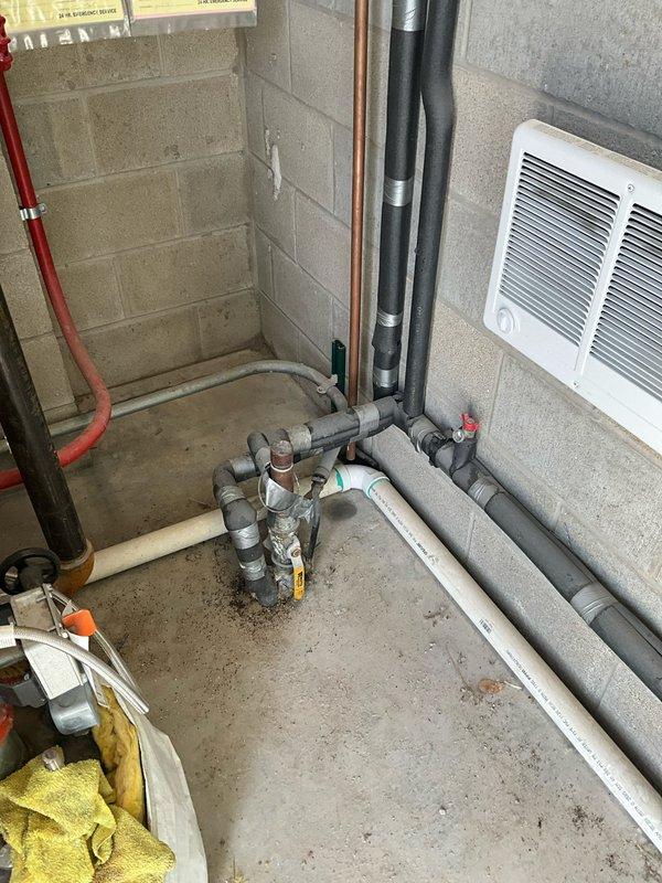 Responded to no hot water complaint at commercial facility. Upon inspection, found Rinnai tankless water heater installed and operational in mechanical room. Verified unit power supply, gas connections, and exhaust venting were properly configured. Tested hot water flow at multiple fixtures throughout building and confirmed adequate hot water delivery to all locations except reported shower head. Traced plumbing distribution system and determined issue was isolated to individual fixture rather than water heater malfunction. Tankless unit displaying normal operating parameters with no error codes present. Recommended client contact plumbing division to inspect shower valve cartridge and fixture-specific supply lines for potential blockage or mechanical failure at point of use.