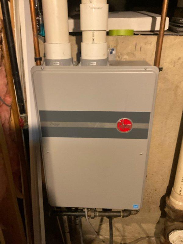 Completed comprehensive tune-up service on wall-mounted tankless water heater unit. Performed thorough inspection of all internal components including heat exchanger, burner assembly, and control board. Cleaned heat exchanger surfaces, verified proper venting through white PVC exhaust pipes, and inspected all copper plumbing connections for leaks or corrosion. Tested unit operation, confirmed proper gas combustion, and verified all electrical connections and safety controls were functioning correctly. Unit returned to normal operating condition with all components performing within manufacturer specifications.