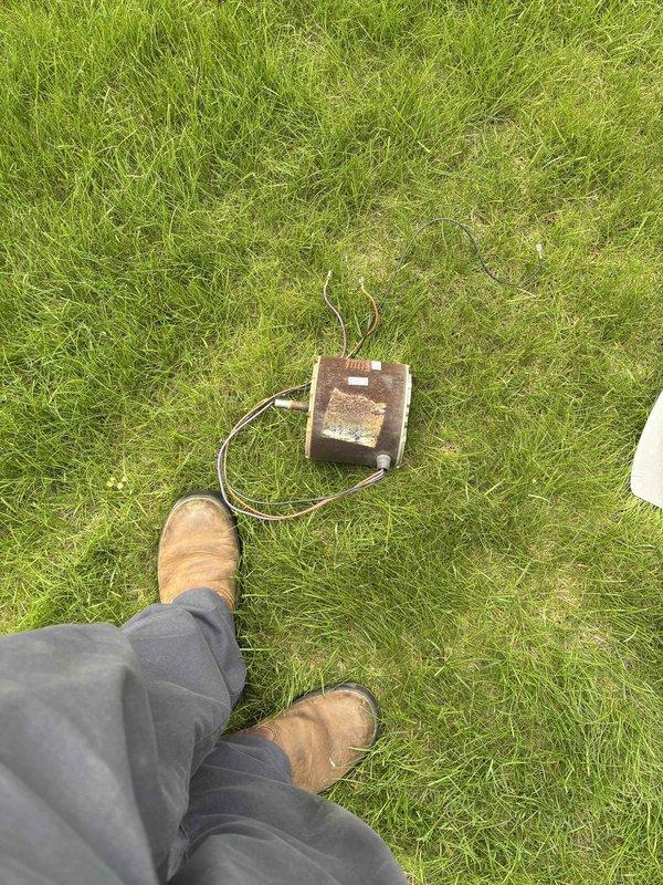 Replaced failed outdoor condenser fan motor due to severe corrosion and deterioration. Removed old motor assembly from unit, installed new motor with protective fan guard and housing, and verified proper operation. Unit restored to full cooling capacity.