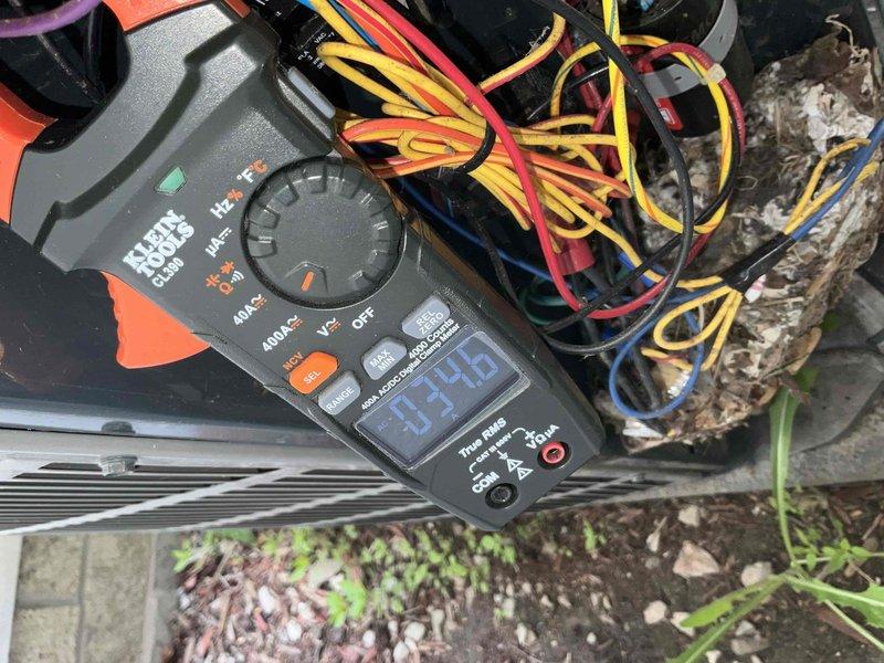 Completed comprehensive BFMA tune-up on 9-year-old furnace system, performing full system diagnostics and operational testing. Inspected outdoor HVAC unit including condenser coil condition, verified electrical connections, and measured current draw using clamp meter with readings at 0.320 amps. All components operating within normal parameters, system running efficiently with no issues identified.