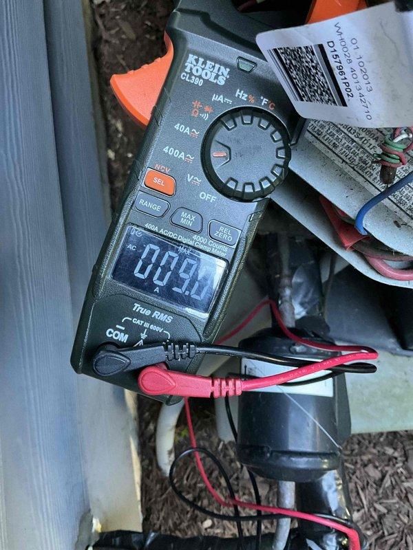 Completed comprehensive HVAC maintenance and tune-up inspection on outdoor heat pump/air conditioning condenser unit. Upon arrival, found extensive dirt, debris, and dust accumulation on cylindrical finned coil structure requiring thorough cleaning to restore optimal heat transfer efficiency. Performed electrical diagnostics using clamp meter, recording amperage readings at 00.2A to verify proper system operation and component function. Cleaned condenser coils, inspected all electrical connections and components including capacitors, and verified system performance meets manufacturer specifications.