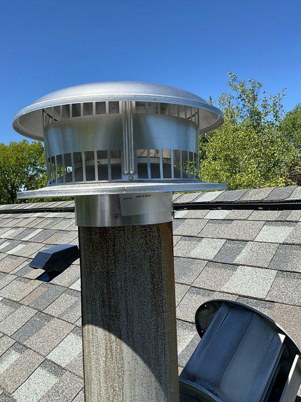 Responded to callback for rescheduled chimney cap replacement appointment. Removed and replaced damaged CMC chimney cap with severely compromised screening, torn baffle, and deteriorated components that were no longer providing proper ventilation or debris protection. Installed new chimney cap from truck stock, ensuring proper fit and secure mounting to cylindrical chimney pipe with appropriate flashing collar to prevent water intrusion.