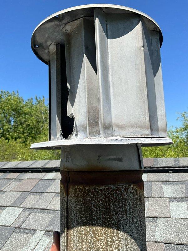 Responded to callback for rescheduled chimney cap replacement appointment. Removed and replaced damaged CMC chimney cap with severely compromised screening, torn baffle, and deteriorated components that were no longer providing proper ventilation or debris protection. Installed new chimney cap from truck stock, ensuring proper fit and secure mounting to cylindrical chimney pipe with appropriate flashing collar to prevent water intrusion.