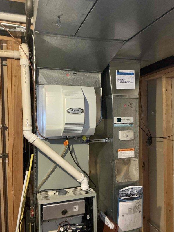 Conducted sales estimate for air conditioning system experiencing significant refrigerant loss. Evaluated existing outdoor condensing unit on concrete pad and indoor evaporator coil assembly with humidifier integration in basement utility area. Recommended complete A/C and coil replacement to address refrigerant deficiency and ensure proper system operation and efficiency.