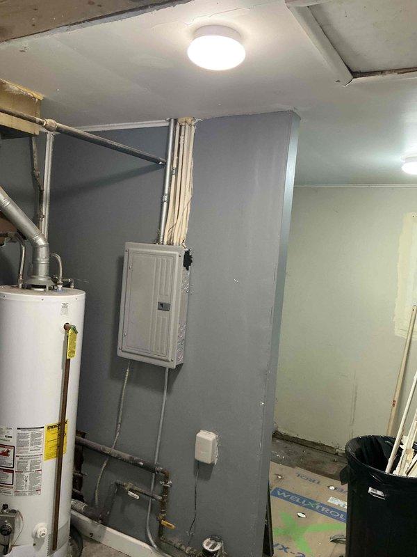 Completed comprehensive estimate for full HVAC system replacement in residential property. Existing furnace requires replacement and property currently lacks air conditioning system, necessitating new AC installation. Assessed electrical panel capacity and existing breaker configuration to ensure adequate power supply for new equipment. Evaluated utility room layout, including current water heater placement, ductwork routing, and available space for new furnace and air conditioning components. Documented existing conditions including concrete flooring, wall-mounted electrical infrastructure, and ceiling clearances to determine optimal equipment positioning and installation requirements.