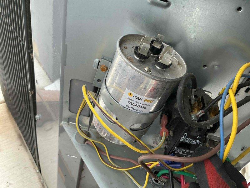 Completed comprehensive BFMA tune-up service on two air conditioning systems, both over 6 years in age. Performed thorough inspection of outdoor condenser unit, noting significant deterioration of protective grille mesh along upper perimeter with debris accumulation. Inspected electrical compartment including TITAN PRO capacitor, contactor relay, and associated wiring connections with yellow, blue, brown, red, and green conductors. Verified proper operation of all electrical components and refrigerant line connections. Coordinated arrival with 30-minute advance notification per customer requirement for morning appointment.