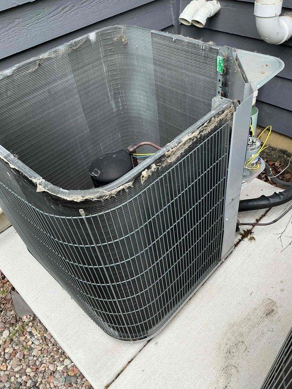 Completed comprehensive BFMA tune-up service on two air conditioning systems, both over 6 years in age. Performed thorough inspection of outdoor condenser unit, noting significant deterioration of protective grille mesh along upper perimeter with debris accumulation. Inspected electrical compartment including TITAN PRO capacitor, contactor relay, and associated wiring connections with yellow, blue, brown, red, and green conductors. Verified proper operation of all electrical components and refrigerant line connections. Coordinated arrival with 30-minute advance notification per customer requirement for morning appointment.