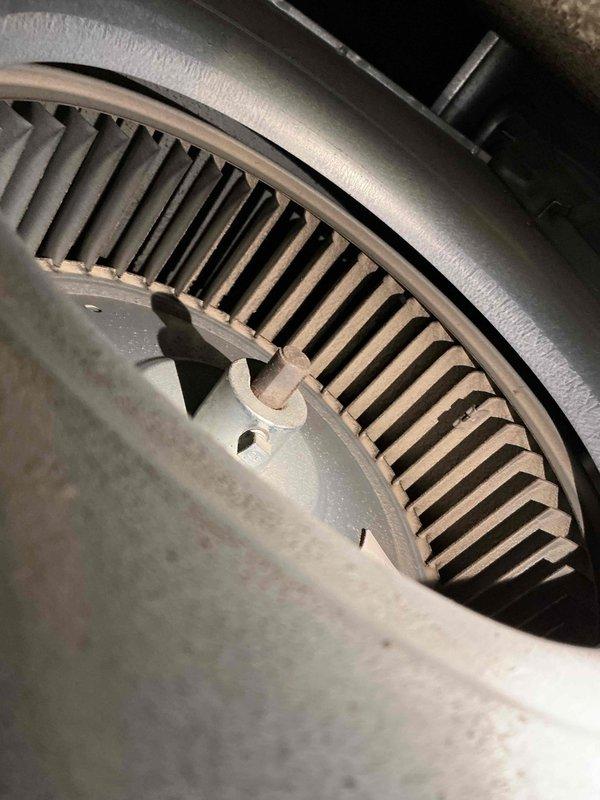Completed comprehensive air conditioning tune-up service including inspection of blower assembly, which showed normal dust accumulation on fan blades and housing. Verified system operation and documented equipment condition, including exterior Generac backup generator unit located on property pad.
