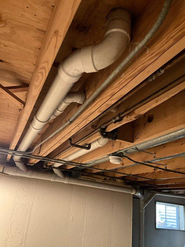 Responded to call for foreign object removal from toilet after washcloth was accidentally flushed. Upon arrival, accessed basement plumbing system to locate affected drainage line. Inspected exposed PVC waste pipe system running through basement ceiling joists to determine blockage location and assess accessibility for extraction. Successfully removed lodged washcloth from toilet drain line, restoring proper flush function and drainage flow. Verified system operation with multiple test flushes to confirm complete clearance and proper water flow through waste line.