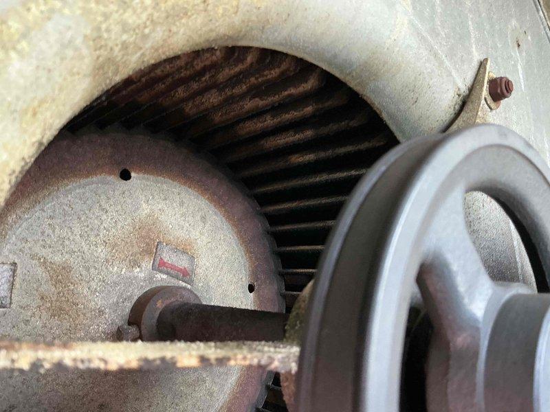 Completed commercial RTU tune-up on Unit 101 at vacant building (former pizza restaurant). Performed standard preventive maintenance procedures including inspection of thermostat operation, motor assembly, and blower components. Documented existing equipment condition showing age-related wear on motor housing and internal components with visible corrosion on coils and pulley assembly.