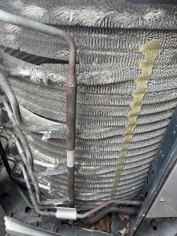 Completed comprehensive BFMA tune-up service on 6-year-old HVAC system including air conditioning unit and air cleaner maintenance. Performed thorough inspection of evaporator coil assembly, which exhibited significant dust and debris accumulation between fins, and assessed refrigerant lines showing normal oxidation and weathering consistent with unit age. Cleaned coil surfaces to restore optimal heat transfer efficiency, removed accumulated dirt and debris from base pan and surrounding components, verified proper refrigerant line connections and insulation integrity, and replaced air cleaner filters as part of semi-annual filter change service. All components tested and confirmed operational following service completion.