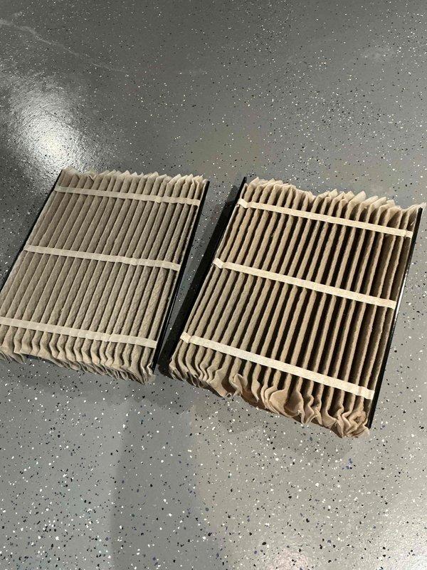 Completed comprehensive BFMA tune-up service on two air conditioning systems with equipment aged 7-20+ years. Performed standard maintenance procedures including inspection of outdoor condenser units, which showed significant dirt and debris accumulation on coil fins requiring cleaning. Replaced heavily soiled air filters on both systems to restore proper airflow and system efficiency.