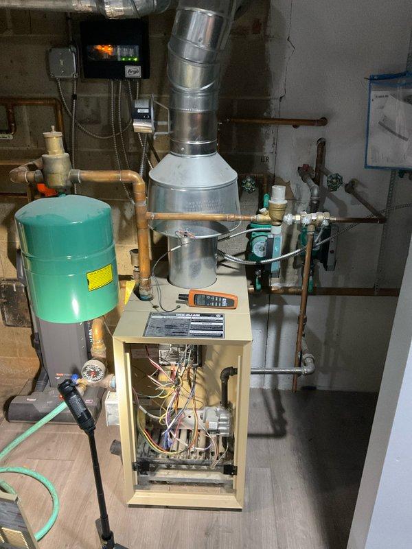Completed comprehensive BFMA tune-up service on 8+ year old heating and cooling system, including full AC maintenance and boiler inspection. Accessed boiler control compartment, verified proper operation of electronic control module displaying normal parameters, inspected all electrical connections and wiring harness for secure terminations. Cycled boiler through operational sequence to verify ignition, flame sensing, and temperature controls functioning correctly per manufacturer specifications, checked expansion tank pressure, inspected all copper piping connections for leaks, and confirmed proper venting system integrity.