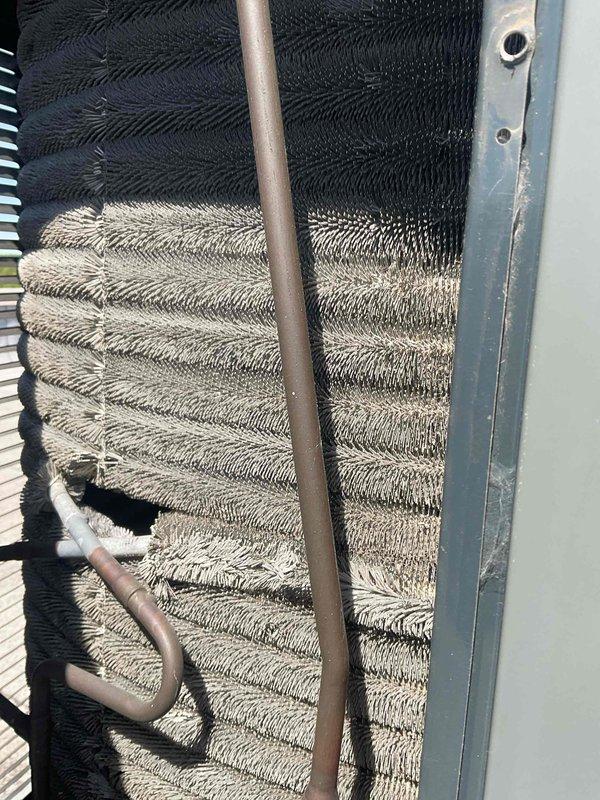 Completed comprehensive BFMA air conditioning tune-up on 9-year-old system. Inspected evaporator coil and identified significant dust and debris accumulation on lower coil section, affecting heat transfer efficiency. Replaced dirty air filter with new unit to restore proper airflow and system performance.
