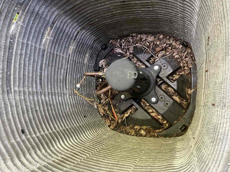 Performed comprehensive BFMA tune-up on residential air conditioning system over 2 years old. Serviced outdoor condenser unit which exhibited significant accumulation of dust, dirt, and debris on cooling fins and substantial leaf buildup around compressor component within housing. Cleaned condenser coils, removed organic debris from unit interior, inspected refrigerant lines and electrical connections, replaced air filters, and verified system operation to restore optimal cooling efficiency.