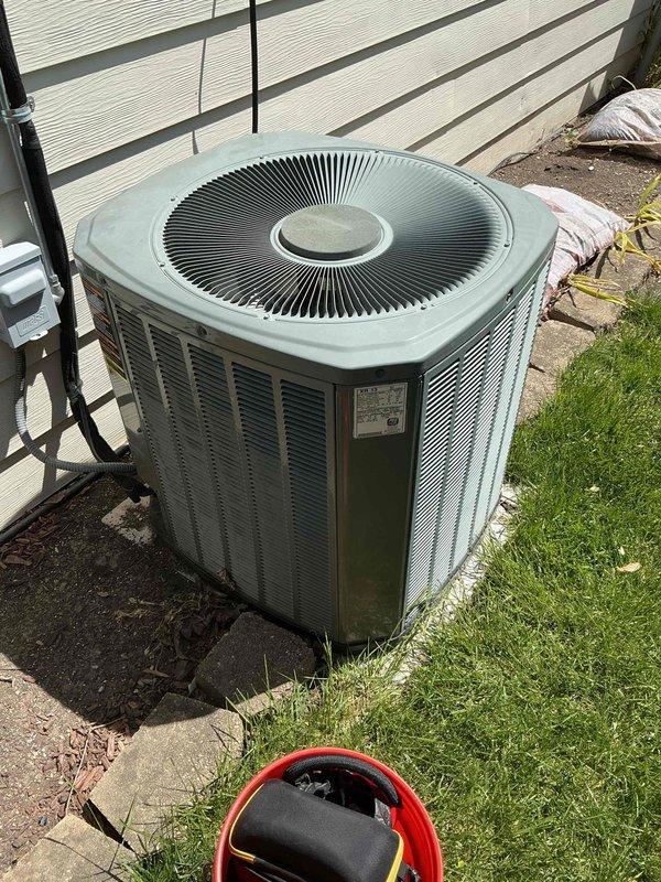 Completed comprehensive BFMA tune-up on 18+ year old outdoor air conditioning condenser unit. Performed standard maintenance protocol including inspection of electrical connections at terminal block, verification of proper wire terminations across all color-coded conductors, assessment of condenser fan operation and grille condition, and evaluation of unit's overall mechanical condition. All electrical connections found secure, condenser coil airflow verified through louvers, and system operational parameters confirmed within acceptable range for equipment age.