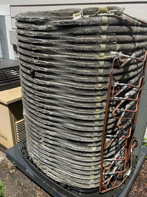 Completed comprehensive BFMA tune-up on 5+ year old residential air conditioning system. Upon arrival, discovered condenser coil heavily contaminated with dirt, dust, and debris accumulation, significantly restricting airflow and reducing system efficiency. Observed abnormal frost buildup on condenser coil and refrigerant lines, indicating potential refrigerant flow restriction or low charge condition. Performed thorough coil cleaning to remove accumulated debris from fins and restore proper airflow. Inspected refrigerant lines, electrical connections, and system components. Documented pre-service and post-cleaning conditions with photographs for maintenance records.