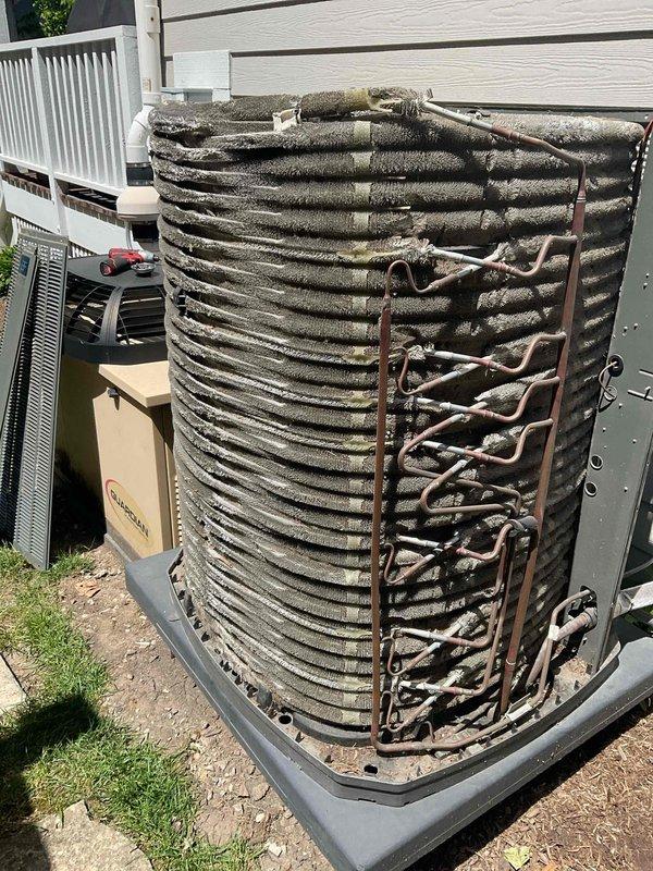 Completed comprehensive BFMA tune-up on 5+ year old residential air conditioning system. Upon arrival, discovered condenser coil heavily contaminated with dirt, dust, and debris accumulation, significantly restricting airflow and reducing system efficiency. Observed abnormal frost buildup on condenser coil and refrigerant lines, indicating potential refrigerant flow restriction or low charge condition. Performed thorough coil cleaning to remove accumulated debris from fins and restore proper airflow. Inspected refrigerant lines, electrical connections, and system components. Documented pre-service and post-cleaning conditions with photographs for maintenance records.