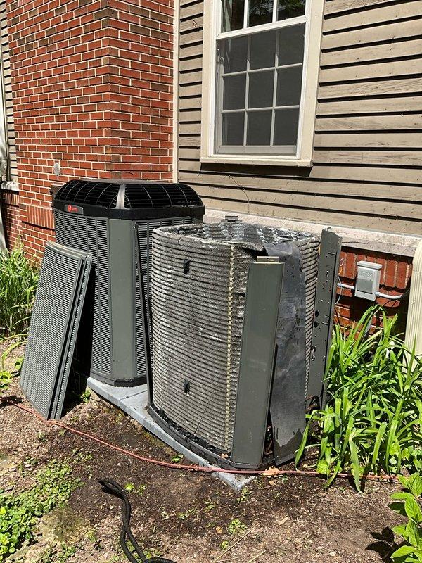 Completed comprehensive BFMA tune-up service on two outdoor AC condensing units at residential property. Performed standard maintenance procedures including inspection of electrical connections, refrigerant lines, and condenser coil conditions on both units. The older unit on the right side showed visible accumulation of debris on condenser fins and required additional cleaning attention. Inspected exterior electrical junction box and wiring connections, noting multiple conductor terminations with evidence of weathering on equipment housing. Verified proper operation of both systems and checked boiler settings as requested. Both AC units operational and ready for cooling season.