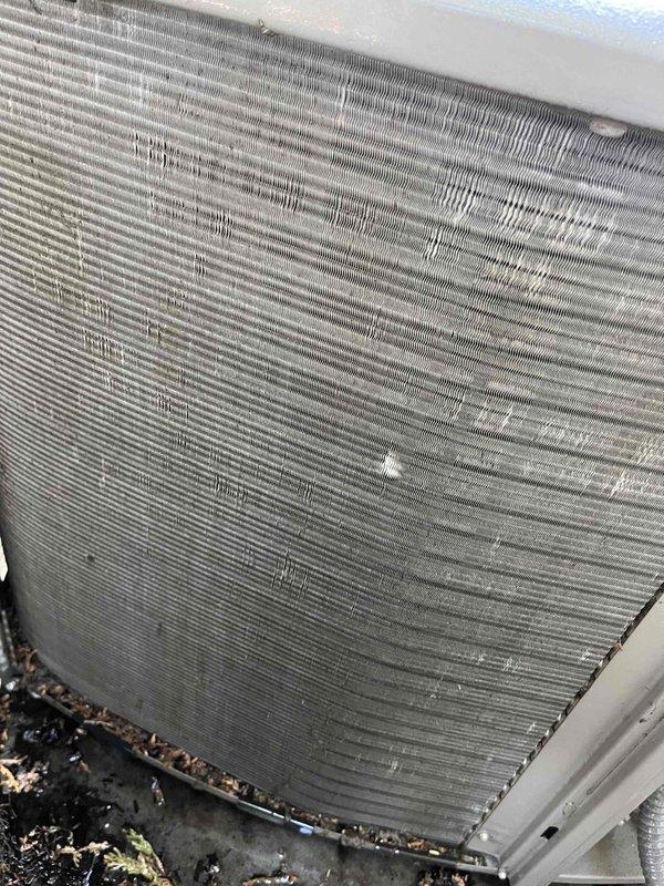 Completed comprehensive tune-up service on two Rheem air conditioning systems, approximately four years old. Performed thorough inspection of outdoor condenser units, noting accumulated environmental debris on coil fins and heat exchanger surfaces. Cleaned condenser coils to remove dirt, pollen, and organic material buildup affecting heat transfer efficiency. Verified proper operation of condenser fan assemblies and checked refrigerant levels. Inspected electrical connections, contactors, and capacitors for both units. Confirmed units are mounted securely on proper pads with adequate clearance for airflow. Both systems operational and ready for cooling season.