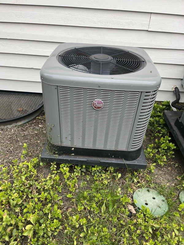Completed comprehensive tune-up service on two Rheem air conditioning systems, approximately four years old. Performed thorough inspection of outdoor condenser units, noting accumulated environmental debris on coil fins and heat exchanger surfaces. Cleaned condenser coils to remove dirt, pollen, and organic material buildup affecting heat transfer efficiency. Verified proper operation of condenser fan assemblies and checked refrigerant levels. Inspected electrical connections, contactors, and capacitors for both units. Confirmed units are mounted securely on proper pads with adequate clearance for airflow. Both systems operational and ready for cooling season.