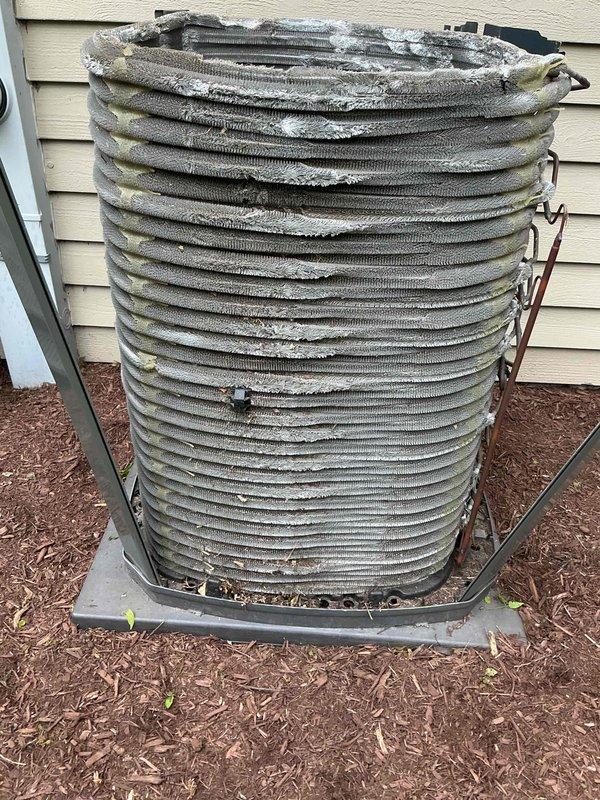 Completed comprehensive BFMA air conditioning tune-up and preventive maintenance service on outdoor condenser unit. Upon arrival, performed visual inspection revealing significant dirt accumulation and debris lodged between coil fins, indicating extended service interval and environmental exposure. Cleaned condenser coils to remove deteriorated insulation material and buildup affecting heat transfer efficiency. Performed electrical diagnostics using clamp meter to verify compressor amperage draw at 21.6 amps, confirming unit operating within normal parameters. Inspected all electrical connections, wiring, and mounting hardware for proper operation. Unit tested and left in operational condition with improved airflow through coils for optimal cooling performance.