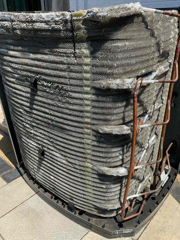 Completed scheduled BFMA air conditioning tune-up and preventive maintenance service on residential heat pump system. Upon arrival, contacted customer 30 minutes prior as requested with no access restrictions noted. Performed comprehensive system inspection revealing heavily deteriorated outdoor coil condition with extensive dirt, dust, and debris accumulation throughout the aluminum fin assembly. The coil fins were severely matted and clogged with thick layers of buildup, particularly dense in upper portions, significantly restricting airflow capacity. Observed weathered copper refrigerant lines with oxidation and discoloration present.

Removed outer casing to access internal components and conducted thorough coil cleaning to restore proper airflow through the heat exchanger. Addressed the consolidated debris blocking fin spacing and cleaned accumulated contaminants from coil surfaces. Inspected indoor air handling unit and examined air filtration system, noting pleated filter media 