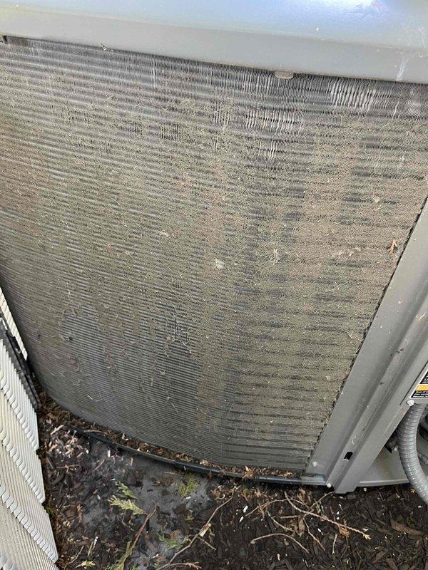 Completed comprehensive BFMA tune-up service on two air conditioning systems. Upon arrival, coordinated 30-minute advance notice as requested and proceeded with full maintenance protocol. Performed detailed system diagnostics using Fieldpiece SMAN refrigerant manifold and micron gauge to verify refrigerant pressures, superheat, and subcooling values on both units. 

Outdoor condenser unit inspection revealed significant debris accumulation and heavy dust buildup restricting airflow through coil fins. Cleaned condenser coils thoroughly to restore proper heat transfer efficiency and airflow capacity. Removed accumulated dirt, lint, and organic debris from unit exterior and surrounding area. Verified all electrical connections, tested capacitors, and confirmed proper amperage draw on compressor and fan motors. Inspected refrigerant lines for leaks and proper insulation. Both systems tested and operating within manufacturer specifications upon completion.