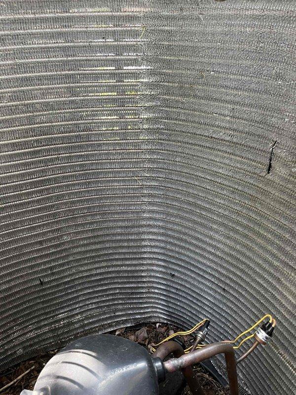 Completed comprehensive BFMA tune-up service on residential HVAC system with equipment age of 1+ years. Performed thorough inspection of condenser unit, including examination of evaporator coil and condenser coil fins which showed moderate accumulation of dirt, dust, and debris. Measured system parameters and documented equipment condition with photographic evidence showing cylindrical heat exchanger coil assembly and compressor unit requiring attention due to contamination between fin rows.