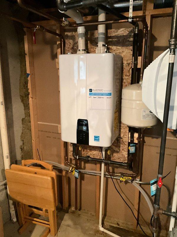 Completed comprehensive plumbing inspection as part of scheduled maintenance tune-up, arriving within the requested morning timeframe. Inspected and documented tankless water heater installation with expansion tank, verifying all copper piping connections, brass fittings, and proper venting in basement utility area. Evaluated sump pump system including basin, discharge piping, electrical connections, and operational functionality to ensure proper water removal capacity.
