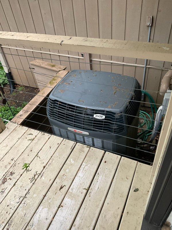 Responded to no cooling call with clicking noise reported at indoor unit. Upon inspection, found outdoor XV20 unit with debris accumulation on top and indoor air handler with visible moisture damage and debris in lower compartment. Diagnosed failed contactor causing clicking sound without compressor engagement. Replaced defective contactor, cleaned debris from outdoor unit coil and top surface, and verified all electrical connections. Cycled system through complete cooling operation, confirmed proper compressor startup, normal amperage draw, and adequate airflow. System restored to full cooling capacity with no abnormal sounds.