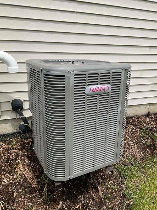Completed comprehensive BFMA tune-up service on 8-year-old Lennox air conditioning system during second scheduled visit following weather delay from initial appointment. Performed full AC maintenance protocol including inspection of outdoor condensing unit, verified proper operation of electrical disconnect, checked refrigerant levels, cleaned condenser coils, inspected condensate drainage system with white PVC piping, and evaluated overall system performance. All components found operating within manufacturer specifications with unit cycling properly and maintaining adequate airflow through ventilation louvers.