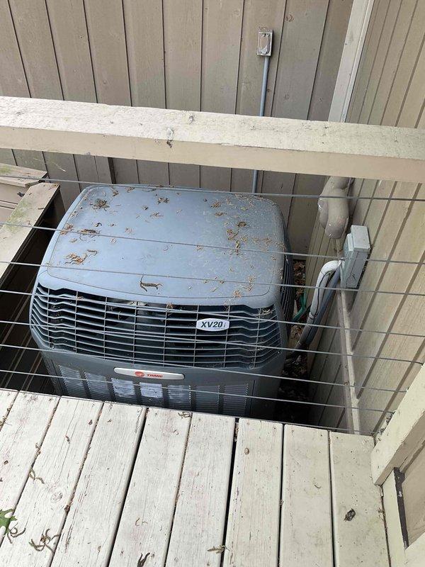 Responded to no cooling complaint and evaluated existing HVAC system consisting of an XV20i variable-speed heat pump and XL1050 control. Documented current equipment condition showing weathering and debris accumulation on outdoor unit. Advised customer that upgrading to high-efficiency Trane equipment utilizing new refrigerant will require replacing the existing XL1050 control due to incompatibility with updated refrigerant specifications. Prepared comprehensive equipment replacement estimate for air conditioning system and coil replacement to restore cooling functionality and improve system efficiency.