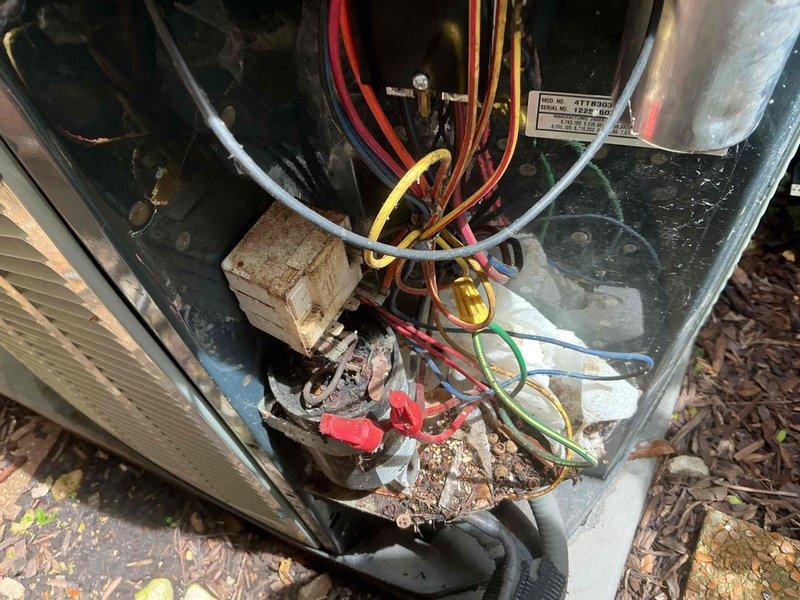 Completed comprehensive BFMA tune-up service on outdoor air conditioning unit. Performed standard preventative maintenance protocol including inspection of electrical connections, capacitor testing, wire condition assessment, and evaluation of compressor housing integrity. Unit showed significant age-related weathering with visible corrosion on electrical components and metal casing; documented existing conditions with photographic evidence for service records. All electrical connections verified secure, system operational upon completion of tune-up procedures.
