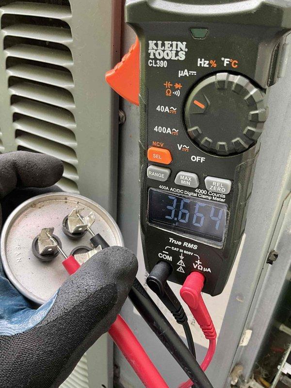 Responded to no-cooling complaint with thermostat set to 68°F and actual temperature at 76°F. Performed diagnostic evaluation of outdoor condensing unit and electrical components. Used digital clamp meter to test capacitor and verify electrical readings, identifying faulty capacitor with abnormal measurements. Replaced defective run capacitor, restored proper system operation, and verified unit cooling effectively.
