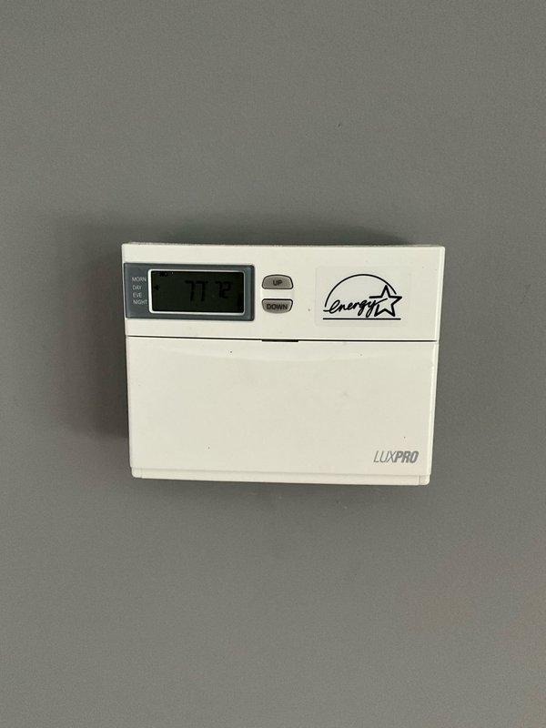 Responded to residential no cooling complaint with reports of weak airflow and insufficient cooling. Upon arrival, performed system diagnostic and inspection of HVAC equipment. Verified thermostat operation and settings on LuxPRO programmable unit displaying 72°F setpoint. Conducted visual inspection of accessible components and documented equipment conditions including Bradford White 50-gallon natural gas water heater (Model: RG1PV50S6N19). System evaluated for airflow restrictions and cooling performance issues as reported by homeowner.